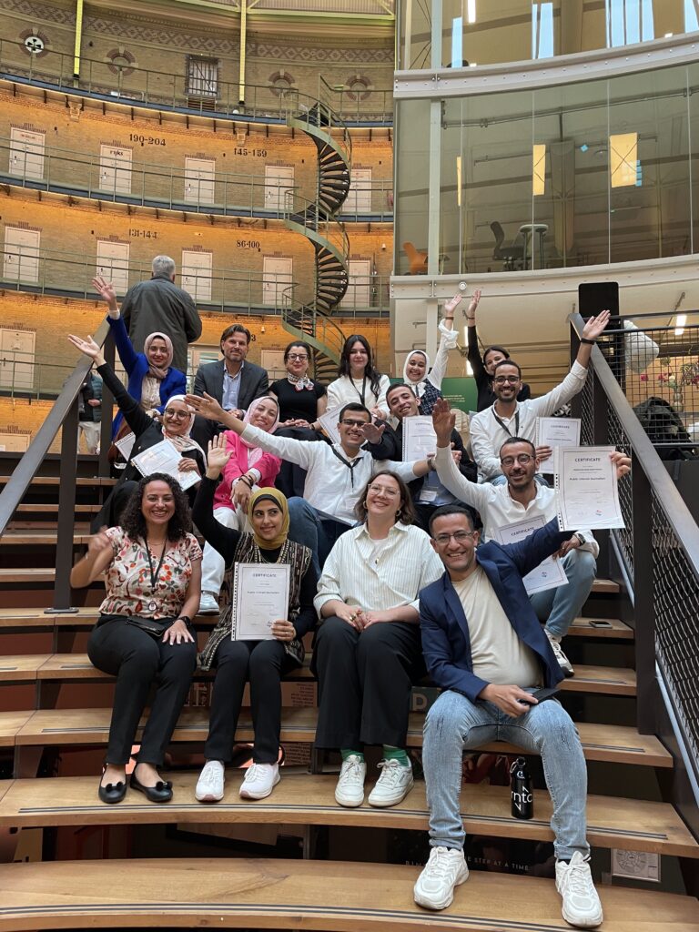 Participants of the CMPB programme pose with their certificates on the stairs of the Koepel